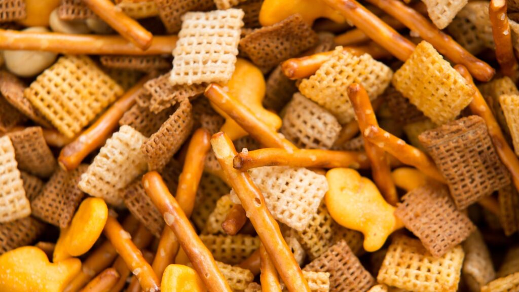 Closeup of snack mix with Chex cereal and goldfish crackers and pretzels